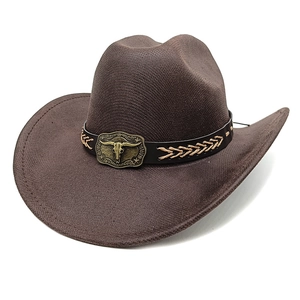 Close-up of brown cowboy hat featuring a vintage metallic bull skull on a leather band