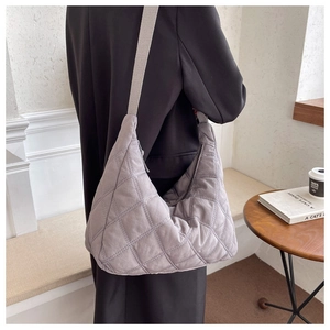 Grey quilted padded shoulder bag with diamond stitching and wide beige strap for women