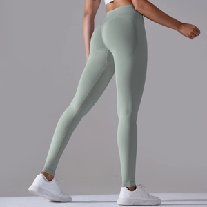 Close-up of seamless mint green yoga leggings with high waist and peach butt lifting design