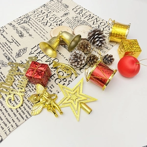 Christmas tree ornament set with gold bells, pine cones, and red gift boxes on white