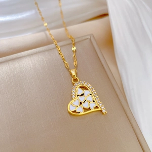 Elegant gold titanium heart necklace with white enamel inlay and sparkling zircon detail