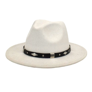 Close-up of the white fedora hat showing the black band with silver studs and metal pieces
