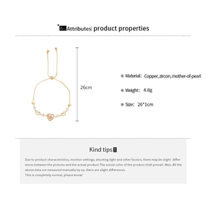 Detail showing copper heart bracelet with white mother-of-pearl and zircon inlay