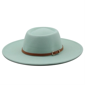 Detail of light green wool felt fedora featuring a brown leather strap and gold buckle