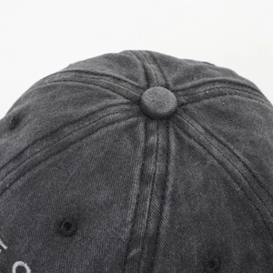 Detailed macro view of washed grey cotton baseball cap crown with stitched eyelets
