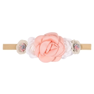Detail of coral pink rose and small white flowers on soft nude nylon baby headband