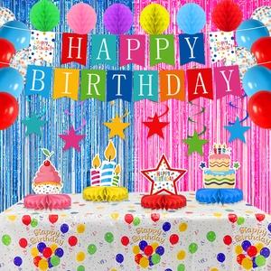 Detailed set of colorful birthday party supplies with banner balloons and tablecloth