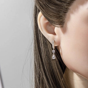 Vintage gold drop earrings featuring sparkling round and teardrop crystals on model