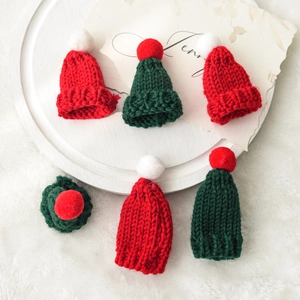 Miniature red and green knitted Christmas hats with white pom-poms for DIY craft decor