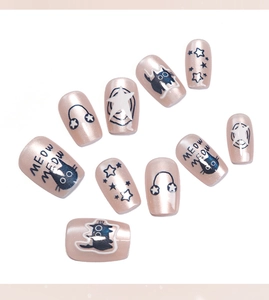 Detail of sweet pink cat-eye press-on nails with cute cat and star patterns