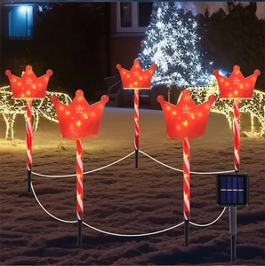 Macro detail of LED solar crown lawn stakes with star cutouts and candy cane poles