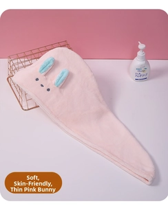 Detail of pink cartoon bunny microfiber hair towel with soft texture and ear design