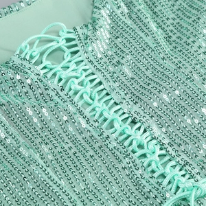 Detail of cross-lace back design on mint green sequin dress for elegant evening events