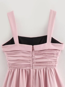 Detail view of pink balloon dress featuring tiered pleated ruffles and hidden back zipper