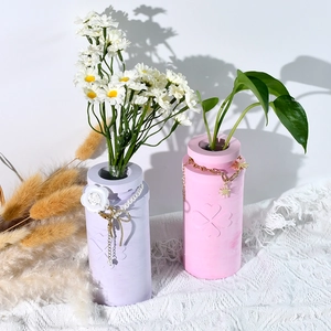 Modern cylinder four-leaf clover vases in pink and purple with floral charms and daisies