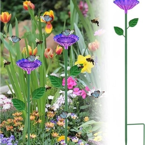 Detail of purple flower-shaped bird feeder in a garden attracting bees and butterflies