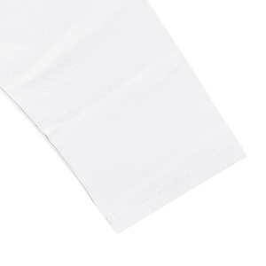 Detail of double-needle stitching and soft cotton fabric texture on white linen set