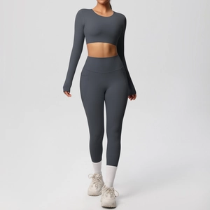 Detail of dark grey yoga set featuring high-waisted leggings with functional side pockets
