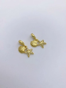 Detailed view of gold starfish and conch pendant charm with paved cubic zirconia stones