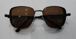 Detailed top view of retro square steampunk sunglasses with amber lenses and metal frame