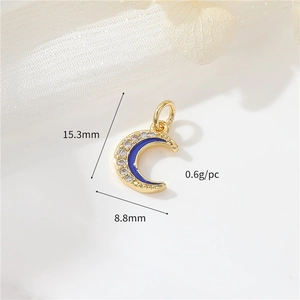 Detail of 14k gold moon pendant with blue enamel and tiny zircons measuring 15.3x8.8mm