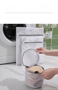 Detailed view of white mesh laundry bags set for delicate clothing and bra protection