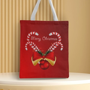 Detailed view of red Christmas canvas tote bag with candy canes and Merry Christmas print