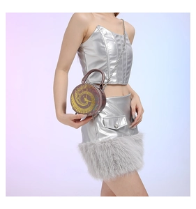 Chic mini round crossbody bag with clock face design worn by model with chain strap