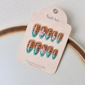 Handmade leopard print press-on nails with 3D floral accents and green French tips