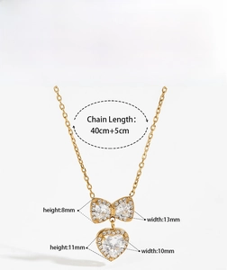 Detail showing gold bow and heart pendant dimensions with necklace chain length specifications