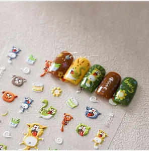 Detailed view of 5D embossed nail stickers featuring cute cartoon cats and fishbone patterns