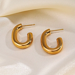 Chunky 18K gold plated stainless steel C-shaped earrings on champagne silk fabric background