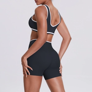 Side view of black yoga set with white contrast trim showing back design and fit