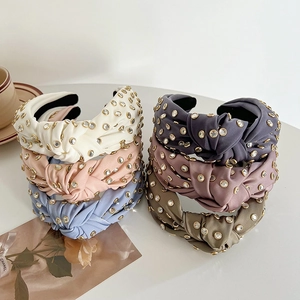 Detail of multi-color knotted satin headbands with rhinestones and anti-slip lining