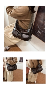 Detail of dark brown vintage high-gloss hobo bag with front pockets and adjustable strap