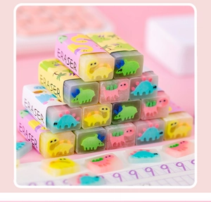 Colorful dinosaur-themed scented jelly erasers stacked on a desk with exercise paper