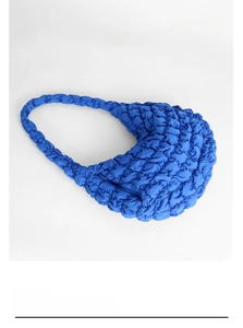 Detailed close-up of blue cloud bag showing pleated bubble texture and soft integrated strap