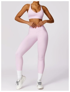 Detail of high-waist seamless compression yoga leggings and sports bra set in pale pink