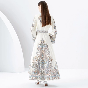 Floral paisley maxi dress with stand collar and flared sleeves on model from back view