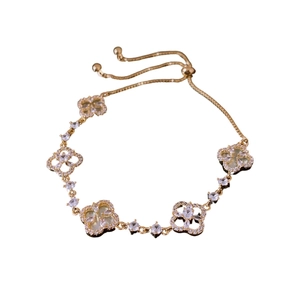 Exquisite gold clover bracelet featuring zircon pavé and shimmering mother of pearl shell