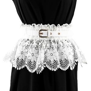 Detail of white floral lace corset belt with gold metal buckle on female waist
