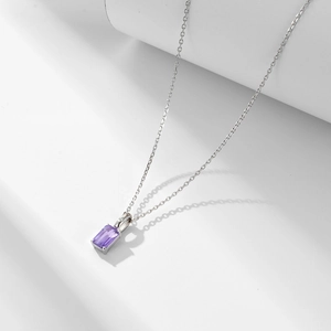 Macro detail of a 925 sterling silver necklace featuring a rectangular purple amethyst pendant