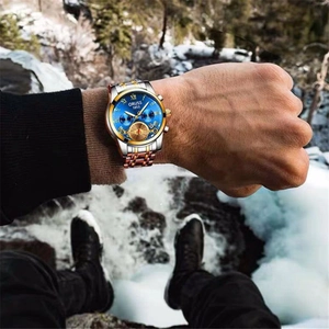 Detail of ORUSS men's steel watch with deep blue sunray dial and gold bezel outdoor