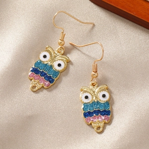 Bohemian colorful owl drop earrings with blue and pink glitter on champagne satin