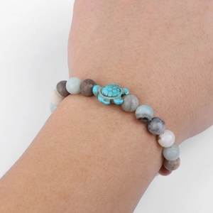 Beaded bracelet with turquoise turtle charm and multicolor natural stone beads on wrist