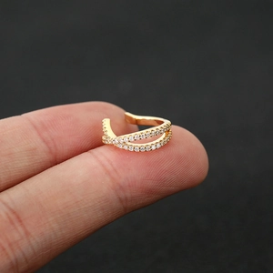 Detail of gold-plated double-layer ear cuff with shimmering white cubic zirconia stones