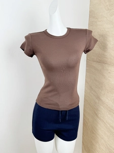 Detailed texture of brown ribbed slim fit T-shirt and navy drawstring shorts set