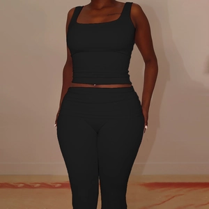 Women's chic black two-piece set featuring a square neck tank top and slim-fit trousers