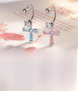 Detail view of 0.8mm cross earrings with pink and blue zircon inlay in titanium steel