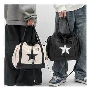 Detail of trendy star logo drawstring tote bags shown in beige and black streetwear style